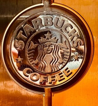 a close up of a starbucks sign on a door